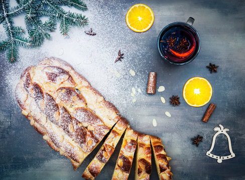 Christmas cake vanocka with hot wine sliced orange and spices on tha gray table