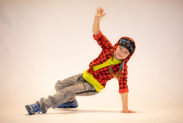 a little girl performs breakdance, a child in a unique acrobatic dance pose,bgirl in action