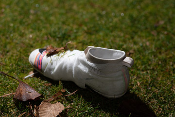 Football shoes showing an injury accident and the end of the career