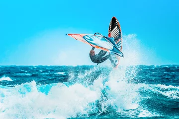  watersports: Windsurfing jumps out of the water © Michele Morrone