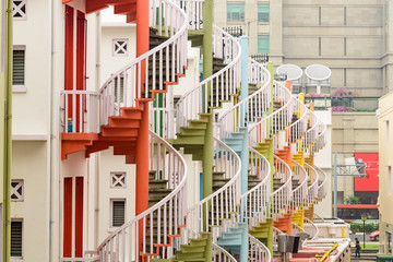 Modern building and traditional rainbow spiral staircases in Singapore