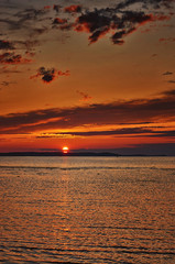 Orange sunset with beautiful sky on the Baltic Sea beach.