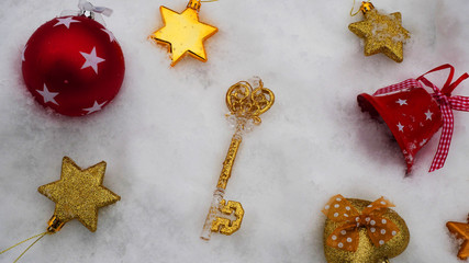 Christmas toys lie on the snow, festive background. The pattern of the toys.