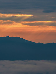 Fototapeta na wymiar mountain landscape with colorful vivid sunset on the cloudy sky
