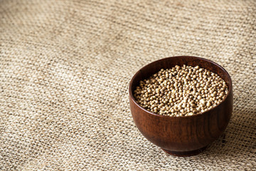 cilantro coriander seeds on wooden bowl