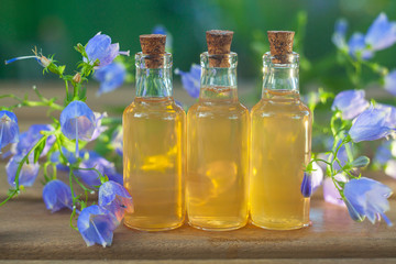 Essence of flowers on table in beautiful glass jar