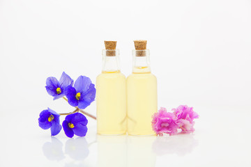 violet essential oil in  beautiful bottle on White background
