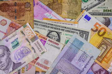 Multi currency background. Euro, american dollars, ukrainian hryvnias, egyptian pounds, russian roubles