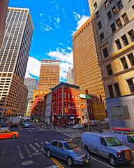 Cars on Street in Financial District at Lower and Downtown Manhattan, New York of USA. Skyline and cityscape with skyscrapers at United States of America, NYC, US. Road and American architecture.