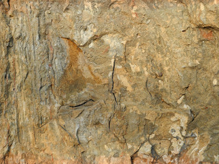 Texture of old weathered stone wall. Yellow gray stone rough background.  