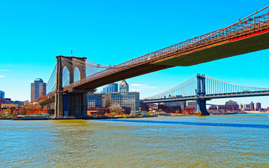 Manhattan and Brooklyn bridge across East River, New York, USA. It is among the oldest in the United States of America. NYC, US. Skyline and cityscape. American construction