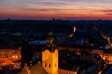 View on illuminated Latin cathedral and historic center of the Lviv at sunset. View on Lvov cityscape from the town hall