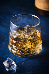 Elegant glass of whiskey with ice.