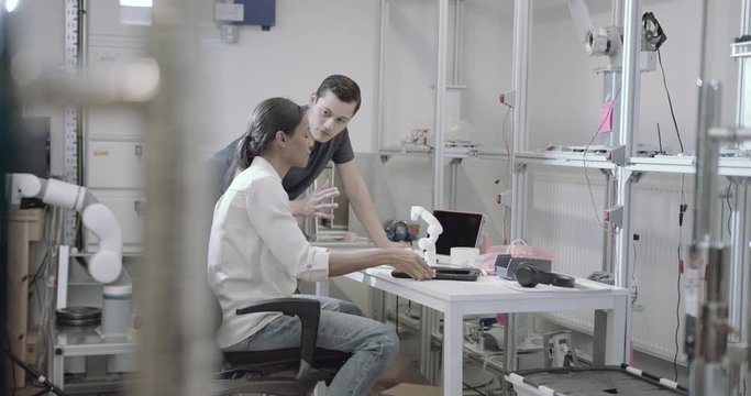 Engineers working on a prototype of robotic arm