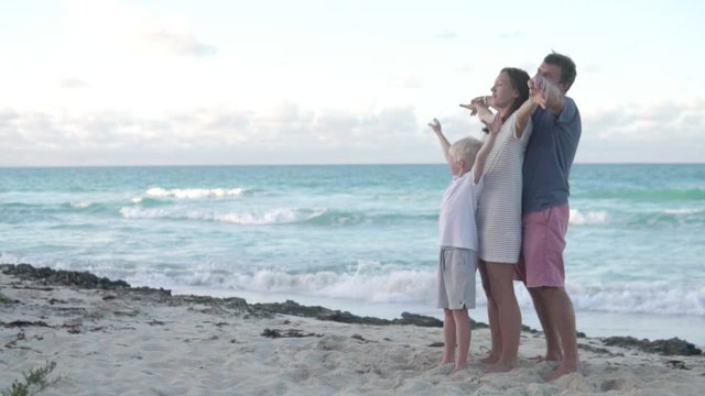 Romantic family with a child by the ocean. December, Cube