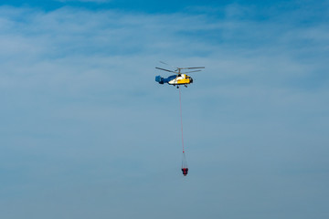 Firefighting helicopter with water tanks