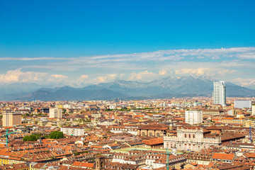Fototapeta premium Aerial PAnoramic summer view on Turin skyline, with the city center, Po river, Mole Antonelliana, modern skyscrapers and other landmark seen from viewpoint the Monte dei Cappuccini on snowy alps Italy