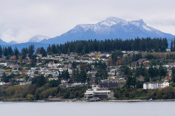 Campbell River, Vancouver Island, British Columbia, Canada. Beautiful view of residential homes on the ocean shore during a cloudy evening.