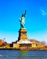 Fototapeta premium Statue on Liberty Island, USA, in Upper New York Bay on Manhattan City Area, America. American architecture building. Metropolis NYC. Cityscape. Hudson, East River NY. Symbol of Freedom.