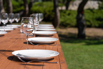 Served wooden table without a tablecloth. Cafe in the open air park