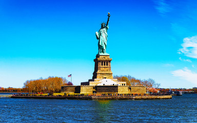 Fototapeta premium Statue on Liberty Island, USA, in Upper New York Bay on Manhattan City Area, America. American architecture building. Metropolis NYC. Cityscape. Hudson, East River NY. Symbol of Freedom.