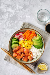 Top view of poke bowl with salmon on light background