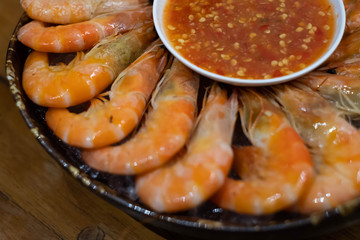 Steamed shrimp on dish with spicy dipping sauce.