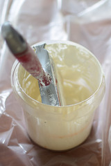 White paint and brush for painting walls. Concept: repair of premises.