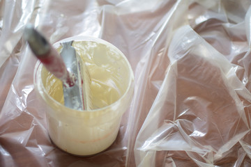 White paint and brush for painting walls. Concept: repair of premises.