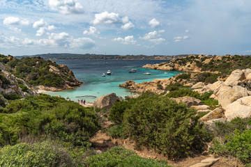 Fototapeta na wymiar The view on Cala Napoletana. Beaches of Caprera Island in The Maddalena Archipelago. Transparent turquoise water in Sardinia, Italy