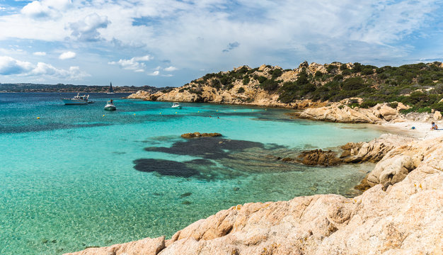 Transparent turquoise water in best beaches of Sardinia, Italy - Cala Napoletana. Beaches of Caprera Island in The Maddalena Archipelago.