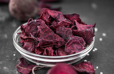 Portion of fresh made Beetroot Chips on a slate slab (selective focus)