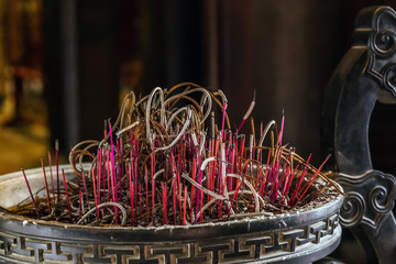 Red colored incense sticks burning buddhist pray