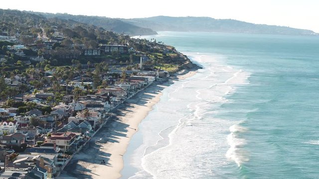 San Diego Del Mar beach aerial people walking Inspire 2 H.264. Medium angle, zoom out perpendicular to coast.