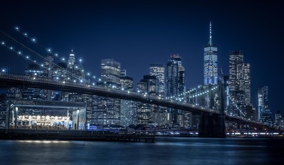 Fototapeta na wymiar brooklyn manhattan bridge night blue city night water sea new york city buildings skyscraper urban lighting prints
