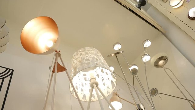Lighting for home and apartment, floor lamps of various designs, beautiful floor lamps in the supermarket window.