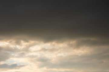 Dark thunder clouds on the blue sky. Abstract background with clouds on blue sky.