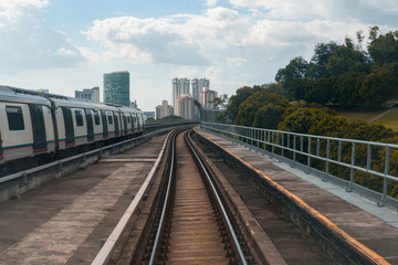 Fototapeta premium Public train track with view of skyscrapers. Transportation concept.
