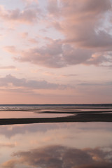 Calming scenic landscape above the sea. Gentle tones of the scenery. Pinky tones of sky. Beauty world. Travel and vacation. Natural background concept. Inspirational vertical photo.