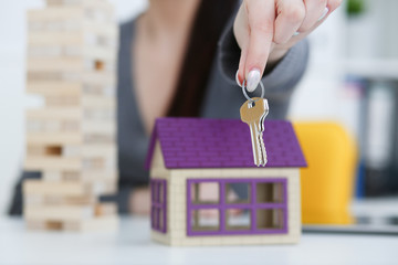 Female hand holds the key to the lock in