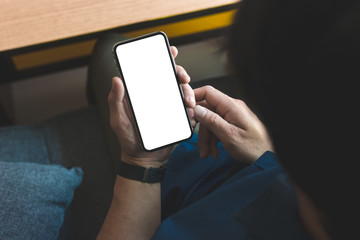 Mockup image blank white screen cell phone.man hand holding texting using mobile on desk at office.background empty space for advertise text.people contact marketing business,technology 