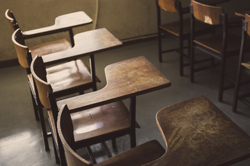 selective soft and blur focus.old wooden row lecture chairs in dirty classroom in poor school.study...