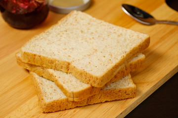 Fototapeta na wymiar Bread sliced on wooden board