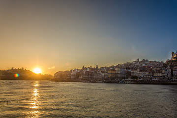 Oporto, Portugal - Douro river and old town ribeira aerial promenade view with colorful houses at sunset