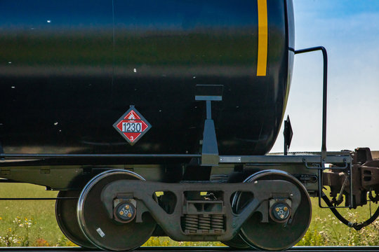 Close up of the tank car of a canadian freight train with 1230 warning sign, category 3. Sign indicates flammable liquid like gasoline or petrol.