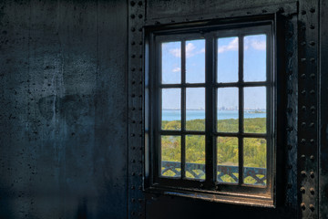 Looking through a lighthouse window at the ocean
