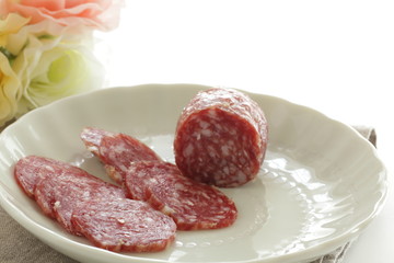 Italian food, salami on dish with copy space