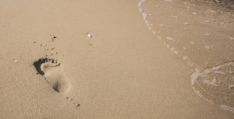 footprint on smooth sandy beach