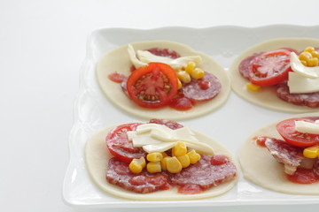 Fusion food, gyoza dough and tomato cheese bake for pizza style