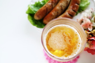 Beef and grilled sausage on white background